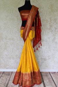 Exude a flair of elegance in this scintillating bright yellow matka banarsi silk saree. It comes with a gorgeous red zari border and complemented well with a contrasting red zari designer blouse. Shop handcrafted silk sarees, linen sari, georgette saree online or visit Pure Elegance store, USA.- full view