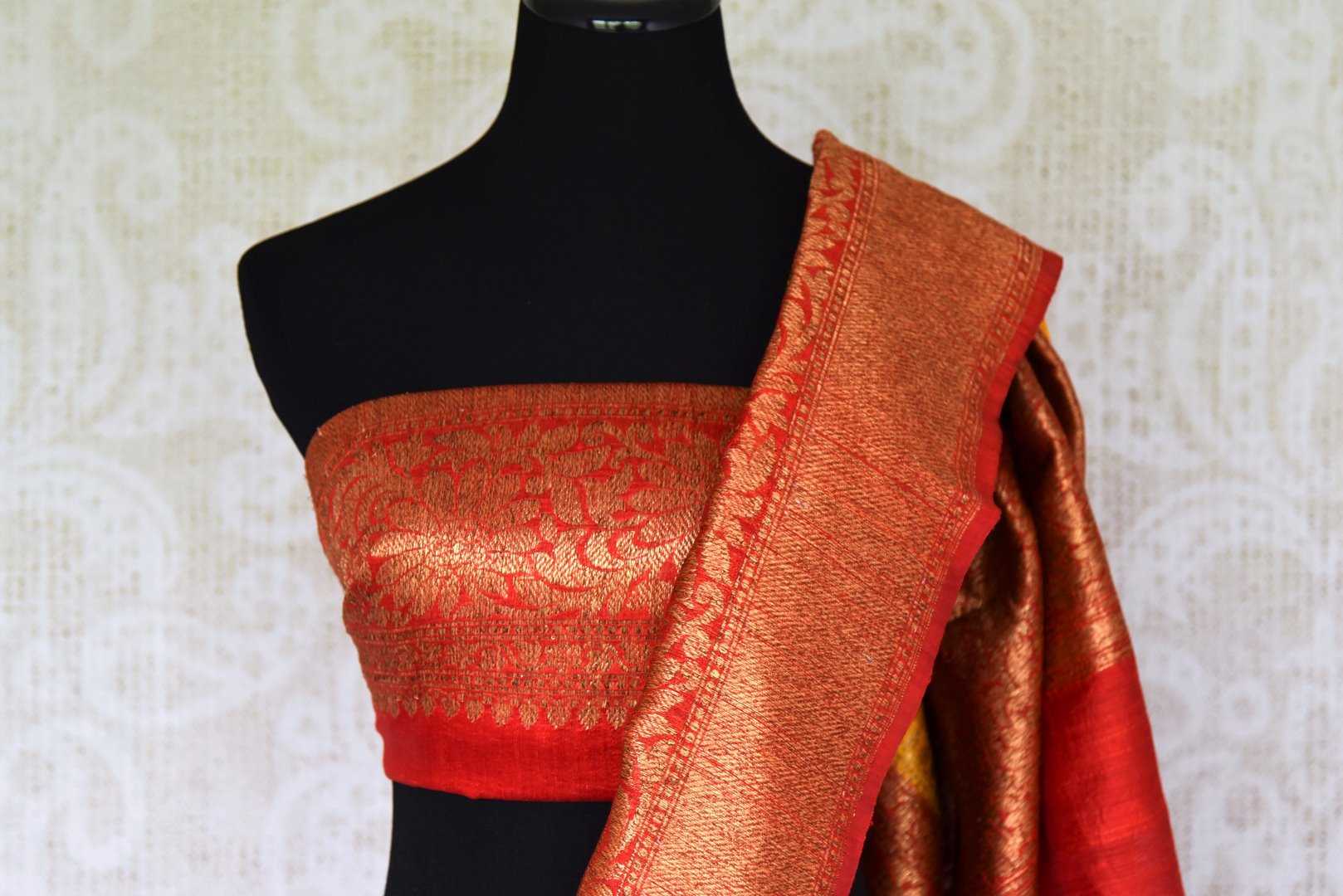 Exude a flair of elegance in this scintillating bright yellow matka banarsi silk saree. It comes with a gorgeous red zari border and complemented well with a contrasting red zari designer blouse. Shop handcrafted silk sarees, linen sari, georgette saree online or visit Pure Elegance store, USA.-blouse pallu