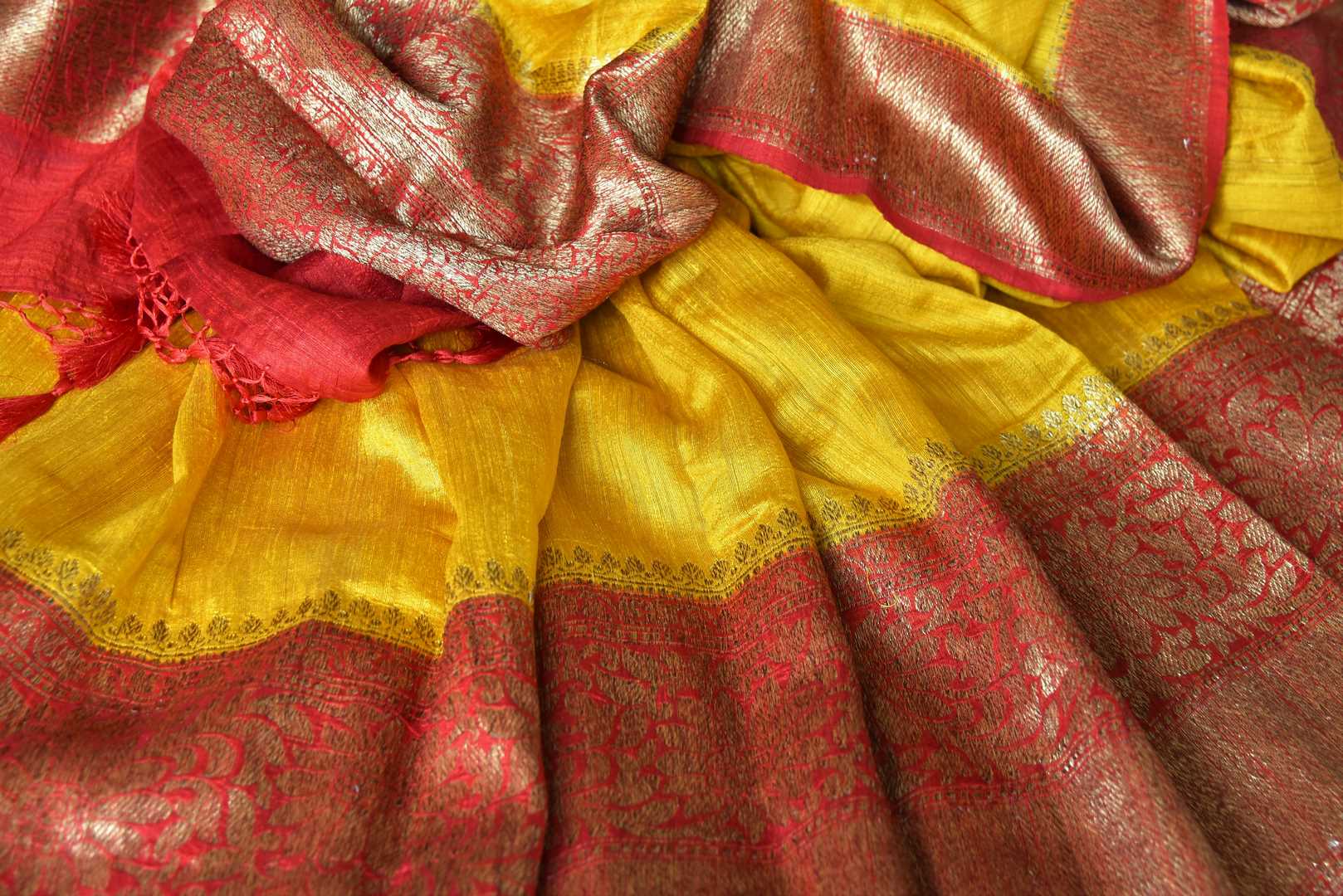 Exude a flair of elegance in this scintillating bright yellow matka banarsi silk saree. It comes with a gorgeous red zari border and complemented well with a contrasting red zari designer blouse. Shop handcrafted silk sarees, linen sari, georgette saree online or visit Pure Elegance store, USA.-details