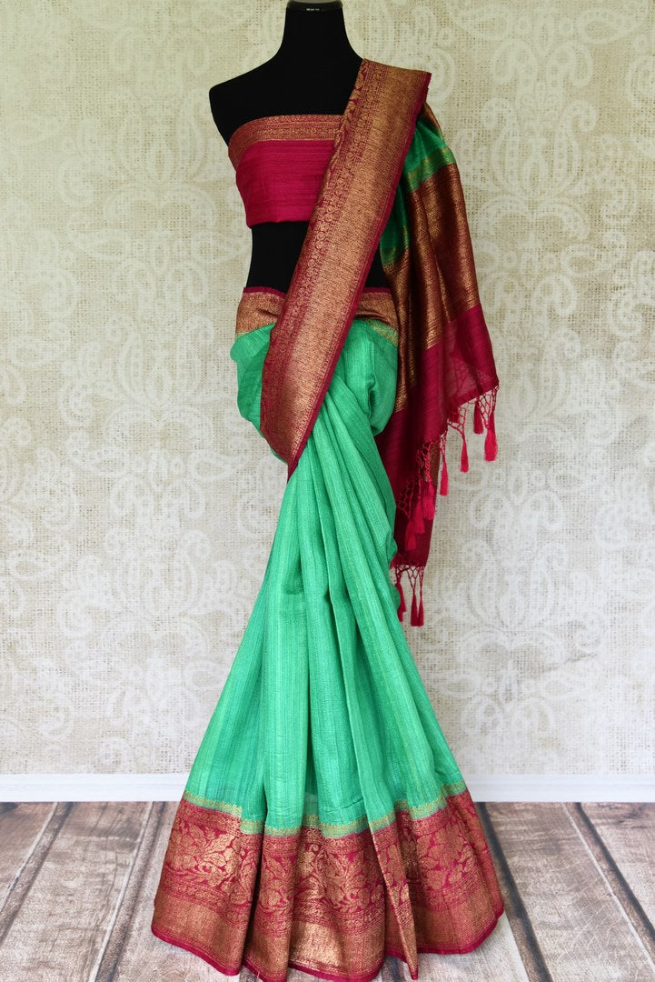 Leave them enthralled as you step up your style game in this mint green matka banarsi silk saree with a stunning red zari border. Elevate your look with a contrasting red zari designer blouse and heavily woven pallu. Shop designer silk sarees, embroidered sari, kalamkari sari online or visit Pure Elegance store, USA.-full view