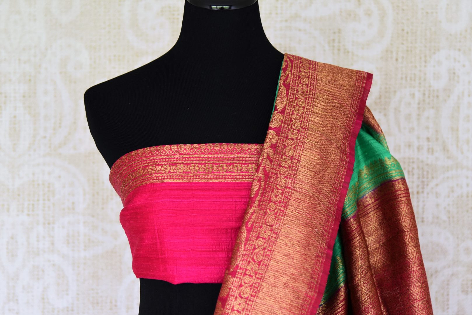 Leave them enthralled as you step up your style game in this mint green matka banarsi silk saree with a stunning red zari border. Elevate your look with a contrasting red zari designer blouse and heavily woven pallu. Shop designer silk sarees, embroidered sari, kalamkari sari online or visit Pure Elegance store, USA.-blouse pallu