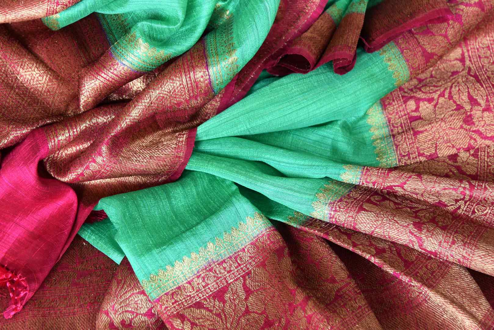 Leave them enthralled as you step up your style game in this mint green matka banarsi silk saree with a stunning red zari border. Elevate your look with a contrasting red zari designer blouse and heavily woven pallu. Shop designer silk sarees, embroidered sari, kalamkari sari online or visit Pure Elegance store, USA.-details