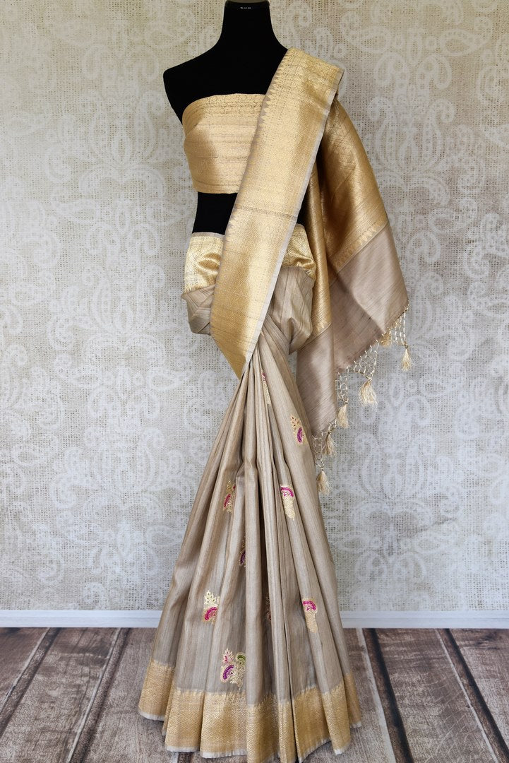 Shop beige tussar Banarasi saree online in USA with floral minakari zari buta. Shop more such exquisite Indian saris in USA from Pure Elegance. Get floored by a range of designer sarees, pure silk sarees, Kanchipuram silk saris at our Indian fashion store in USA.-full view