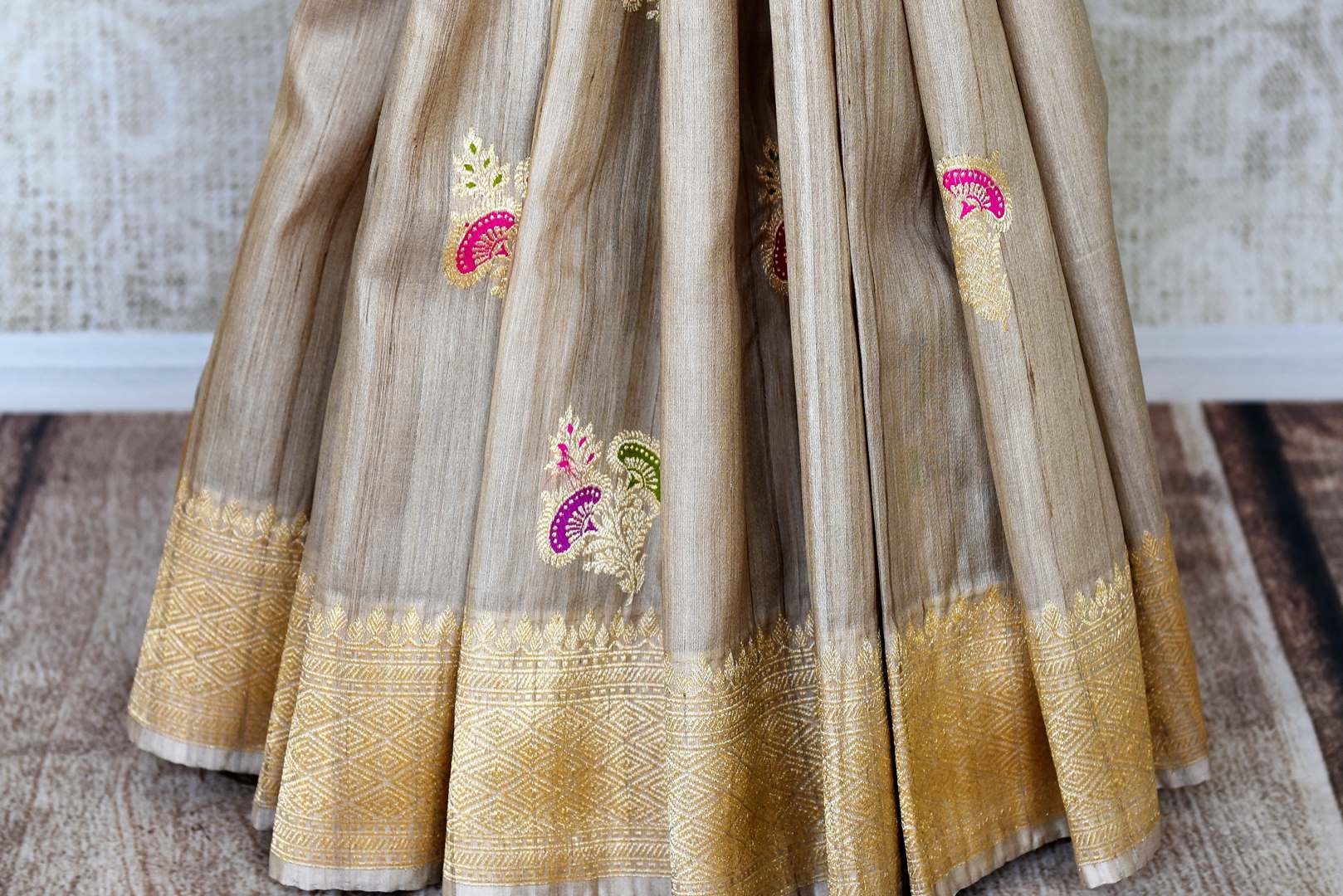 Shop beige tussar Banarasi saree online in USA with floral minakari zari buta. Shop more such exquisite Indian saris in USA from Pure Elegance. Get floored by a range of designer sarees, pure silk sarees, Kanchipuram silk saris at our Indian fashion store in USA.-pleats