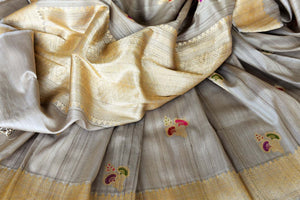 Shop beige tussar Banarasi saree online in USA with floral minakari zari buta. Shop more such exquisite Indian saris in USA from Pure Elegance. Get floored by a range of designer sarees, pure silk sarees, Kanchipuram silk saris at our Indian fashion store in USA.-details