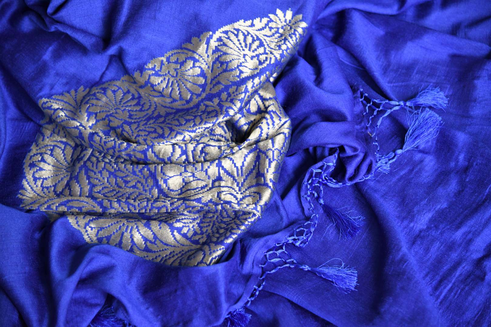 Enchant the folks in this royal blue muga silk saree. It comes with gorgeous silver zari detailing on the pallu. Style this stunning sari with a contrasting red zari designer blouse. Shop handcrafted silk sarees, linen sari, georgette sari online or visit Pure Elegance store, USA.-details