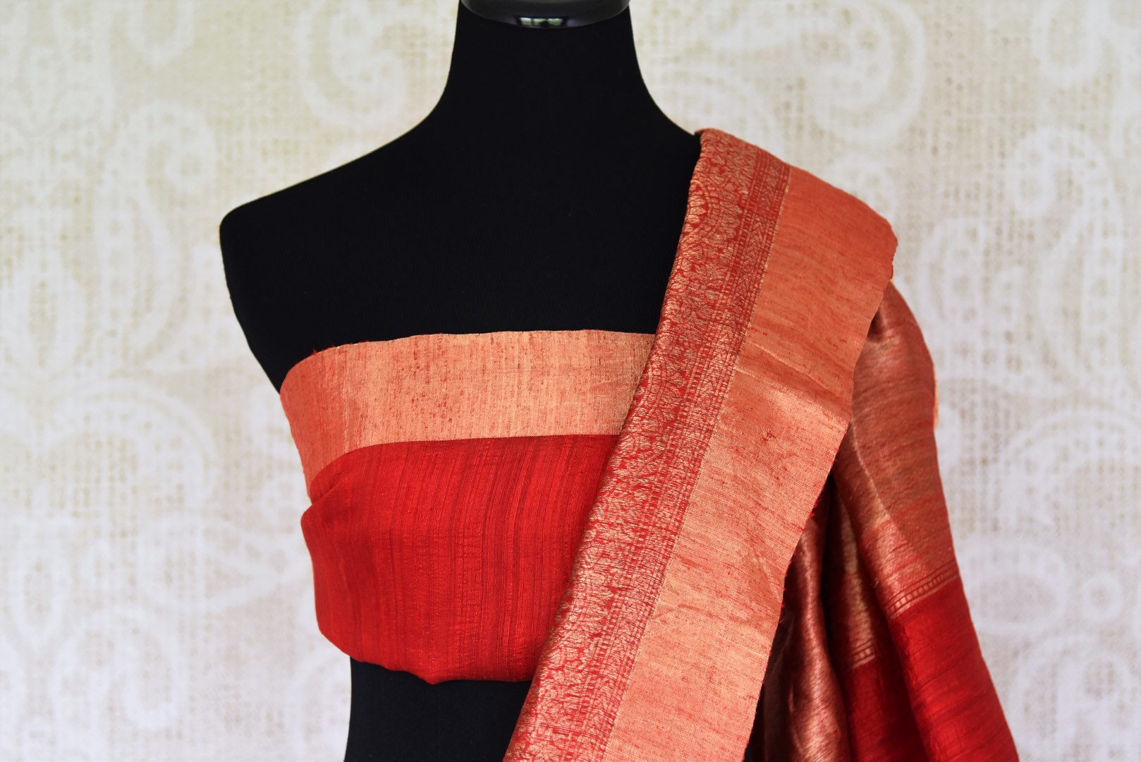 Unleash the royalty in you draping this cream matka banarsi silk sari. It comes with a gorgeous red zari border and a contrasting red blouse. The heavily woven pallu further enhances the beauty of this sari. Shop designer printed sarees, silk sari, linen saree online or visit Pure Elegance store, USA.-blouse pallu