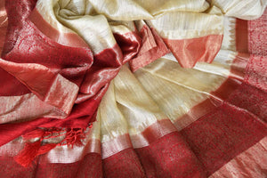Unleash the royalty in you draping this cream matka banarsi silk sari. It comes with a gorgeous red zari border and a contrasting red blouse. The heavily woven pallu further enhances the beauty of this sari. Shop designer printed sarees, silk sari, linen saree online or visit Pure Elegance store, USA.-details