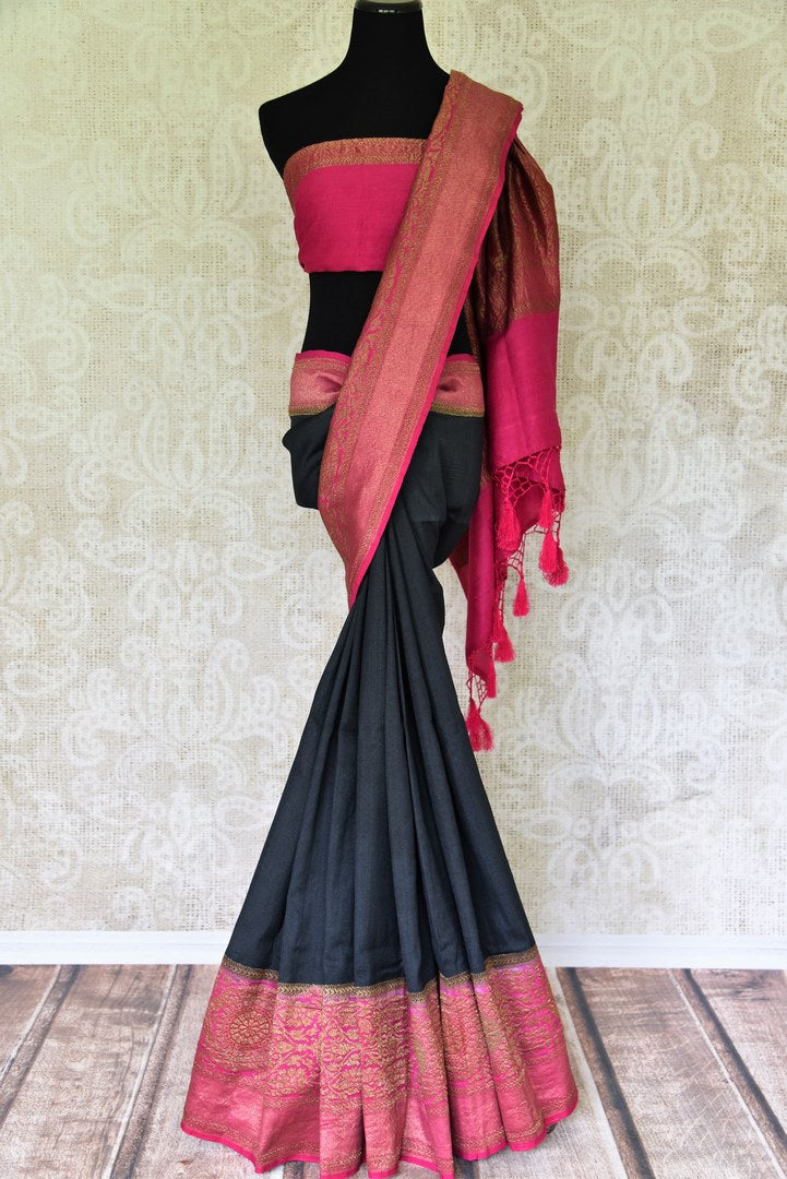 Strut the town in this glorious black muga silk saree curated with finesse. Style this sari with a gorgeous contrasting pink plain blouse that complements the pink zari border and heavily woven pallu. Shop banarsi silk sarees, embroidered sari, georgette sari online or visit Pure Elegance store, USA.-full view