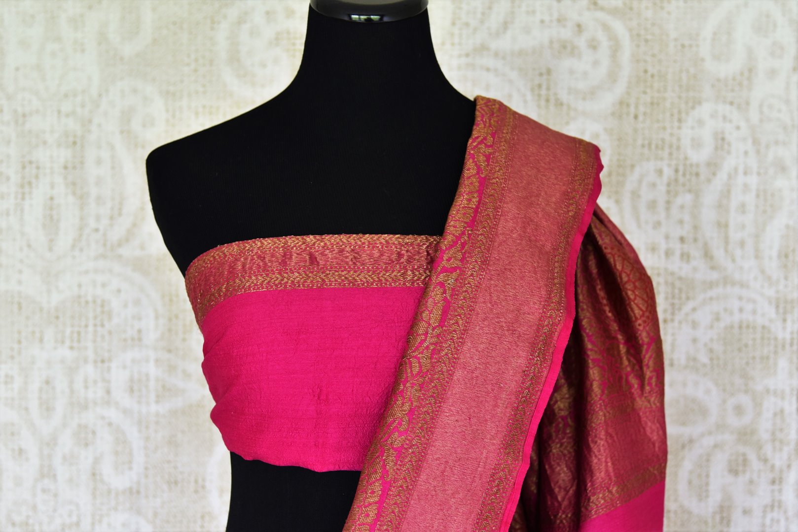 Strut the town in this glorious black muga silk saree curated with finesse. Style this sari with a gorgeous contrasting pink plain blouse that complements the pink zari border and heavily woven pallu. Shop banarsi silk sarees, embroidered sari, georgette sari online or visit Pure Elegance store, USA.-blouse pallu