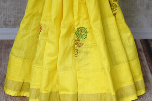Shop bright yellow muga Banarasi saree online in USA with floral buta from Pure Elegance online store. Visit our exclusive Indian clothing store in USA and get floored by a range of exquisite Indian Kanjivaram saris, Banarasi sarees, silk sarees, Indian jewelry and much more to complete your ethnic look.-pleats
