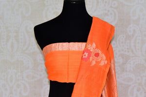 Shop beautiful orange muga Banarasi saree online in USA with floral buta from Pure Elegance online store. Visit our exclusive Indian clothing store in USA and get floored by a range of exquisite Indian Kanjivaram saris, Banarasi sarees, silk sarees, Indian jewelry and much more to complete your ethnic look.-blouse pallu