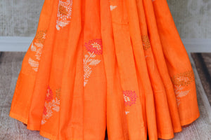 Shop beautiful orange muga Banarasi saree online in USA with floral buta from Pure Elegance online store. Visit our exclusive Indian clothing store in USA and get floored by a range of exquisite Indian Kanjivaram saris, Banarasi sarees, silk sarees, Indian jewelry and much more to complete your ethnic look.-pleats