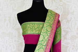 Shop black georgette Benarasi sari online in USA with green pink floral zari border from Pure Elegance online store. Visit our exclusive Indian clothing store in USA and get floored by a range of exquisite pure handloom sarees, Banarasi sarees, silk sarees, Indian jewelry and much more to complete your ethnic look.-blouse pallu