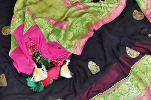Shop black georgette Benarasi sari online in USA with green pink floral zari border from Pure Elegance online store. Visit our exclusive Indian clothing store in USA and get floored by a range of exquisite pure handloom sarees, Banarasi sarees, silk sarees, Indian jewelry and much more to complete your ethnic look.-details