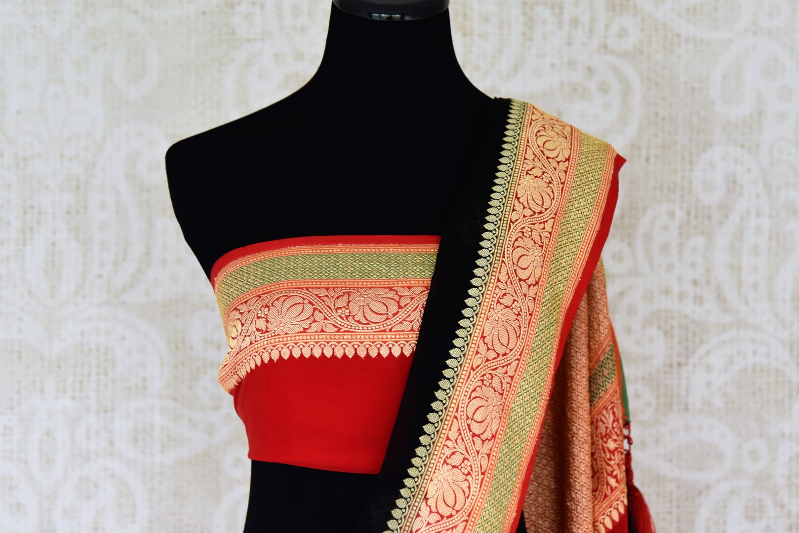Buy stunning black georgette Benarasi saree online in USA with red floral zari border from Pure Elegance online store. Visit our exclusive Indian clothing store in USA and get floored by a range of exquisite pure handloom sarees, Banarasi sarees, silk sarees, Indian jewelry and much more to complete your ethnic look.-blouse pallu
