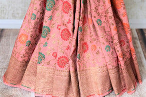 Shop pink color muga Banarasi sari online in USA with floral zari and minakari work from Pure Elegance online store. Visit our exclusive Indian clothing store in USA and get floored by a range of exquisite pure handloom sarees, Banarasi sarees, silk sarees, Indian jewelry and much more to complete your ethnic look.-pleats