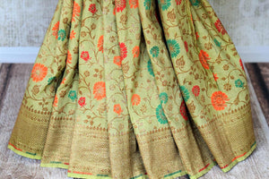 Shop green color muga Banarasi saree online in USA with floral zari and minakari work from Pure Elegance online store. Visit our exclusive Indian clothing store in USA and get floored by a range of exquisite pure handloom sarees, Banarasi sarees, silk sarees, Indian jewelry and much more to complete your ethnic look.-pleats