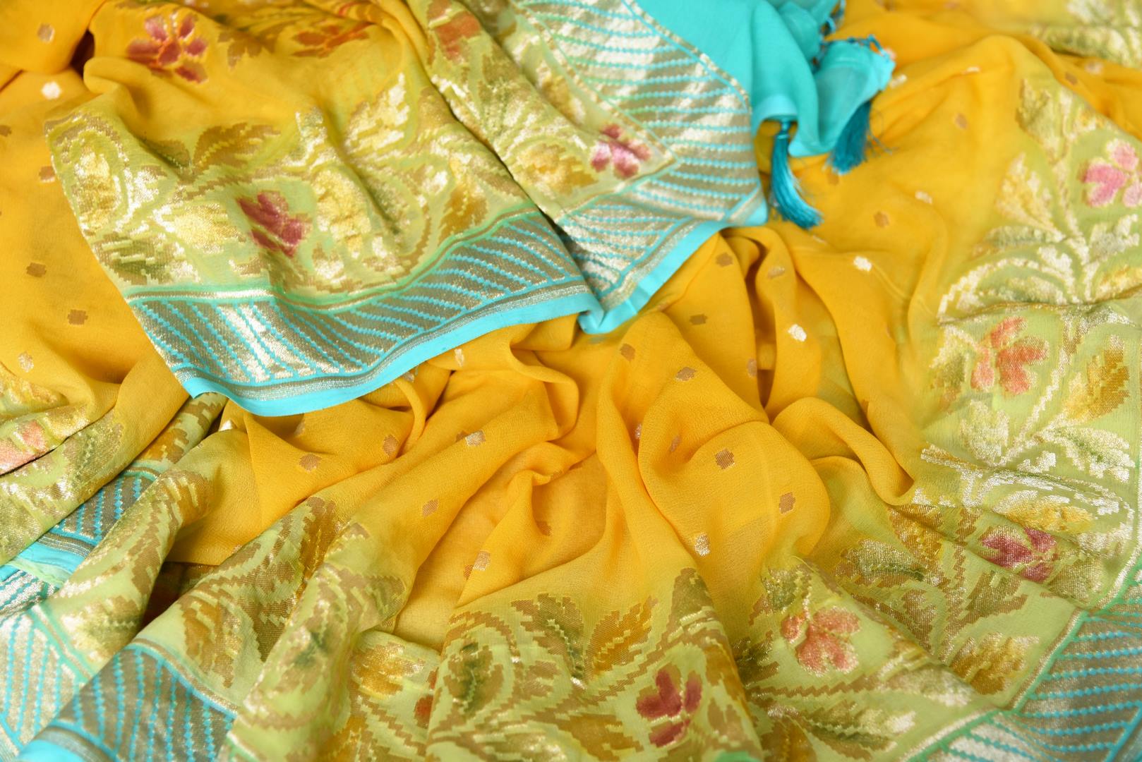 Shop yellow Banarasi georgette saree online in USA with floral zari border from Pure Elegance online store. Visit our exclusive Indian fashion store in USA and get floored by a range of exquisite pure handloom sarees, Banarasi sarees, silk sarees, Indian jewelry and much more to complete your ethnic look.-details