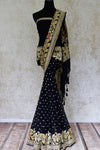Buy black georgette Benarasi sari online in USA with floral zari border. Find a splendid collection of Indian designer sarees with blouses in USA at Pure Elegance Indian clothing store. Make a striking appearance on festive occasions by shopping from a range of pure silk saris, Banarasi sarees, embroidered saris from our online store.-full view