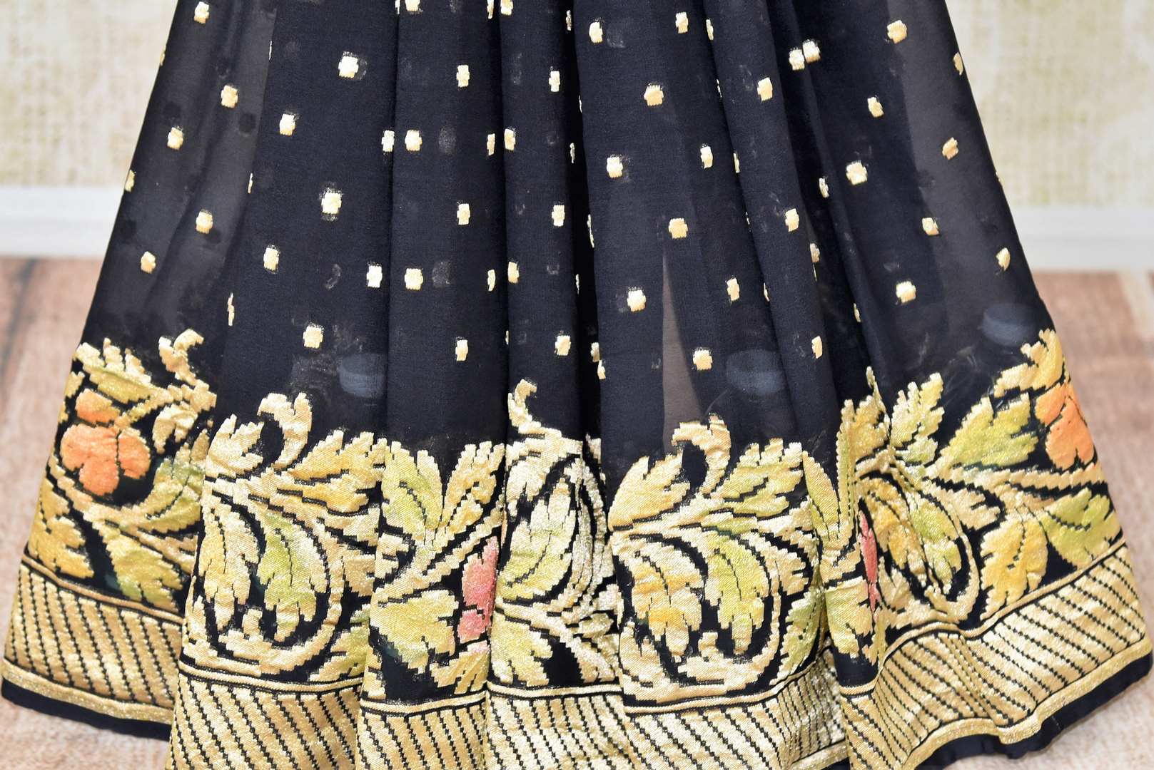 Buy black georgette Benarasi sari online in USA with floral zari border. Find a splendid collection of Indian designer sarees with blouses in USA at Pure Elegance Indian clothing store. Make a striking appearance on festive occasions by shopping from a range of pure silk saris, Banarasi sarees, embroidered saris from our online store.-pleats