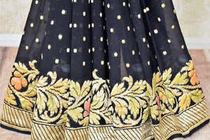 Buy black georgette Benarasi sari online in USA with floral zari border. Find a splendid collection of Indian designer sarees with blouses in USA at Pure Elegance Indian clothing store. Make a striking appearance on festive occasions by shopping from a range of pure silk saris, Banarasi sarees, embroidered saris from our online store.-pleats