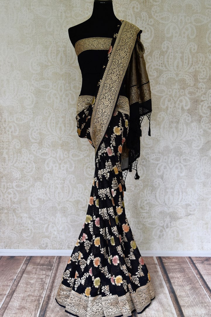 Shop black georgette Banarasi saree online in USA with floral zari work. Find a splendid collection of Indian designer sarees with blouses in USA at Pure Elegance Indian clothing store. Make a striking appearance on festive occasions by shopping from a range of pure silk saris, Banarasi sarees, embroidered saris from our online store.-full view