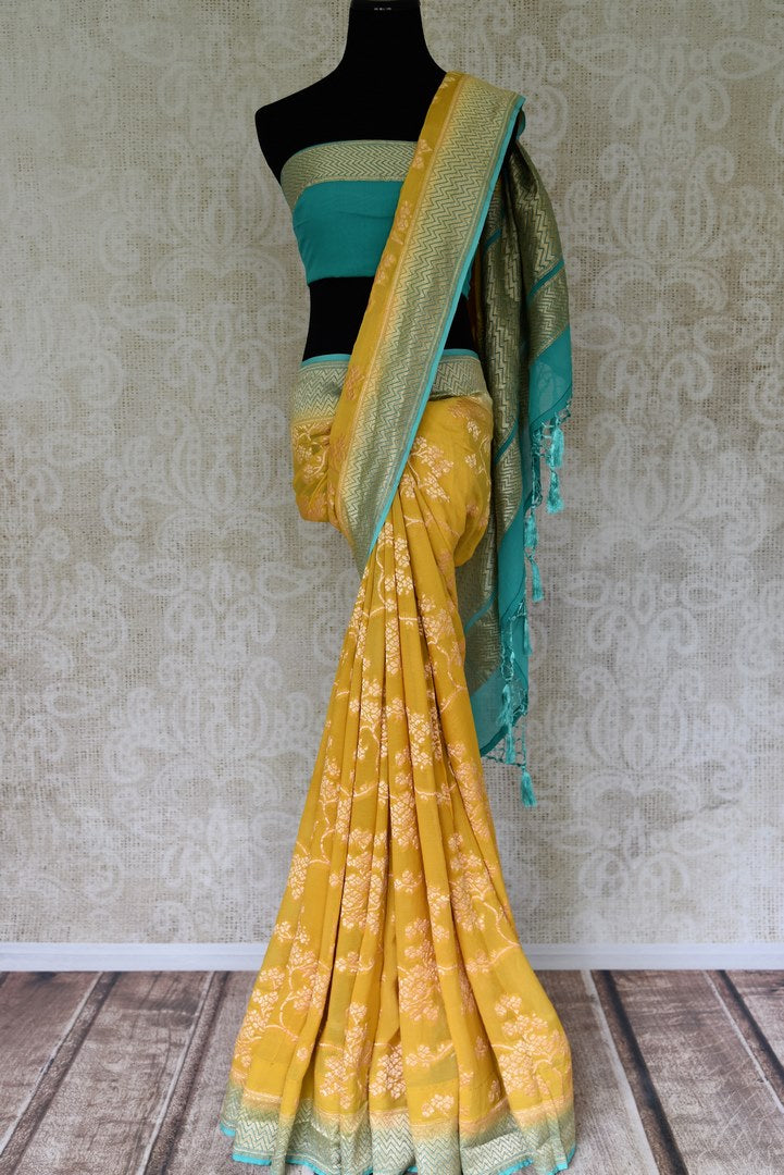 Buy yellow Banarasi georgette saree online in USA with blue zari border. Find a splendid collection of Indian designer sarees with blouses in USA at Pure Elegance Indian clothing store. Make a striking appearance on festive occasions by shopping from a range of pure silk saris, Banarasi sarees, embroidered saris from our online store.-full view