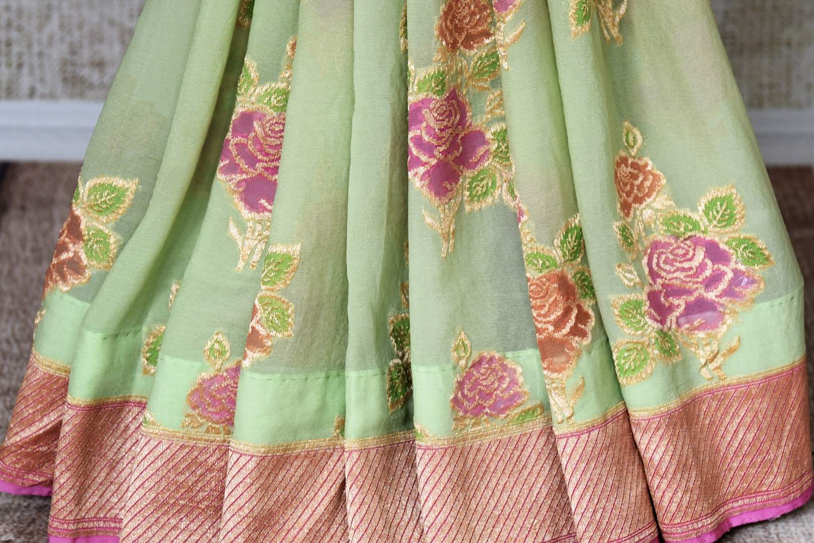 Buy pista green Banarasi georgette sari online in USA with floral zari motifs. Find a splendid collection of Indian designer sarees with blouses in USA at Pure Elegance Indian clothing store. Make a striking appearance on festive occasions by shopping from a range of pure silk saris, Banarasi sarees, embroidered saris from our online store.-pleats