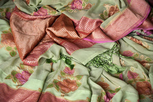 Buy pista green Banarasi georgette sari online in USA with floral zari motifs. Find a splendid collection of Indian designer sarees with blouses in USA at Pure Elegance Indian clothing store. Make a striking appearance on festive occasions by shopping from a range of pure silk saris, Banarasi sarees, embroidered saris from our online store.-details