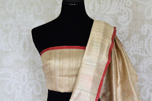Shop beige tussar Benarasi saree online in USA with bright floral border. Find a splendid collection of Indian handloom saris with in USA at Pure Elegance Indian clothing store. Drape yourself in beautiful pure silk saris, Banarasi sarees, embroidered saris on festive occasions from our online store.-blouse pallu
