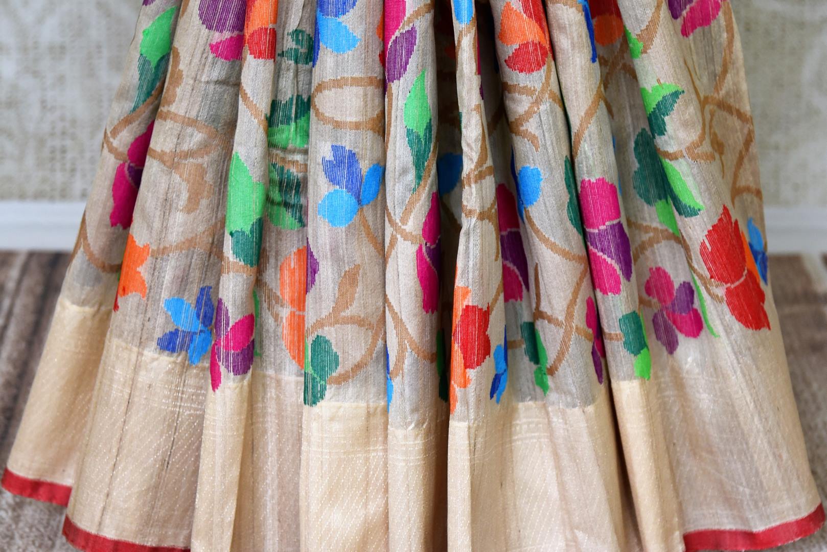 Shop beige tussar Benarasi saree online in USA with bright floral border. Find a splendid collection of Indian handloom saris with in USA at Pure Elegance Indian clothing store. Drape yourself in beautiful pure silk saris, Banarasi sarees, embroidered saris on festive occasions from our online store.-pleats