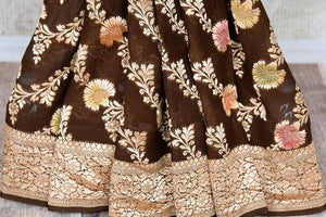 Buy brown color Benarasi georgette sari online in USA with minakari zari floral creeper design. Shine bright on special occasions with traditional Indian sarees, Banarasi sarees, pure silk sarees in rich colors and designs from Pure Elegance Indian fashion store in USA.-pleats