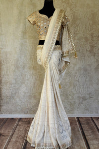 Shop off-white Lucknowi embroidery saree with designer blouse online in USA. Shop more such Indian designer saris, embroidered sarees, pure silk sarees in USA from Pure Elegance clothing fashion store this wedding season.-full view