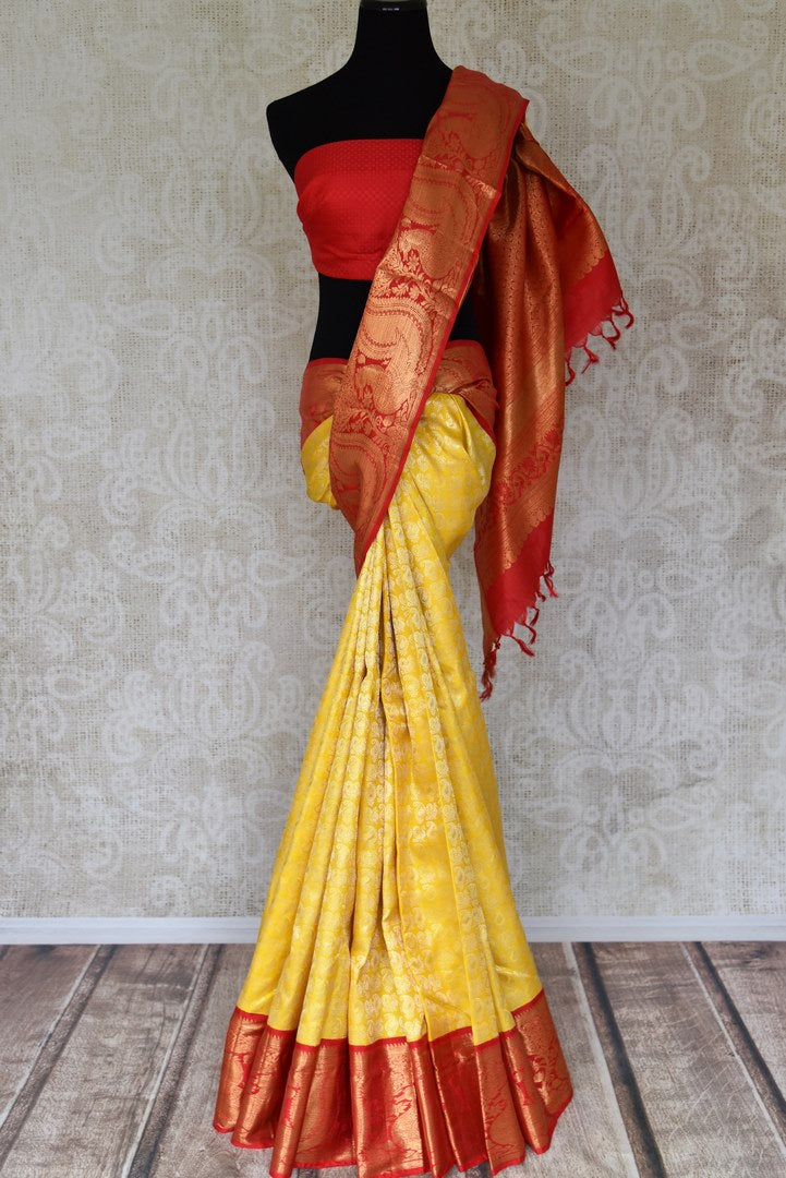 Buy yellow Kanchipuram silk sari with red zari border online in USA from Pure Elegance. Make your ethnic style perfect with a range of exquisite Indian designer saris with blouses, embroidered sarees, pure handloom sarees available at our exclusive Indian fashion store in USA and also on our online store. Shop now.-full view