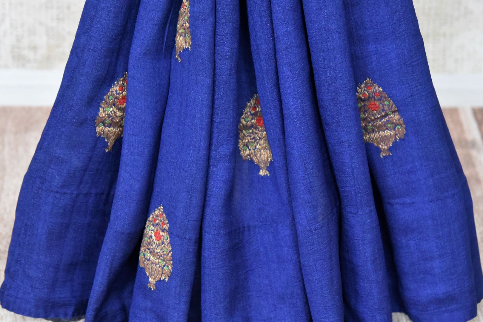 Buy blue muga silk saree online in USA with zari buta and orange zari pallu from Pure Elegance Indian clothing store in USA. Refresh your wardrobe this wedding season with an exquisite range of Indian designer sarees, traditional Banarasi saris, embroidered sarees from our store in USA or shop online.-pleats