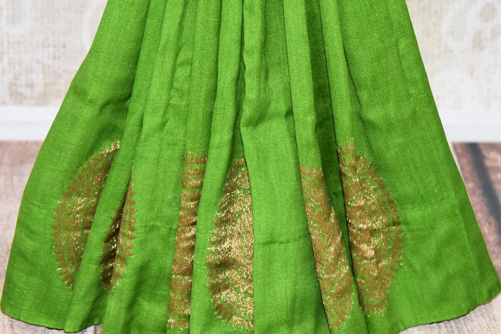 Buy beautiful green muga silk saree online in USA with big floral chakra zari buta. Dazzle on special occasions in ethnic wear from Pure Elegance. Explore a range of exquisite Indian designer sarees, pure silk saris, handwoven sarees at our exclusive Indian fashion store in USA.-pleats