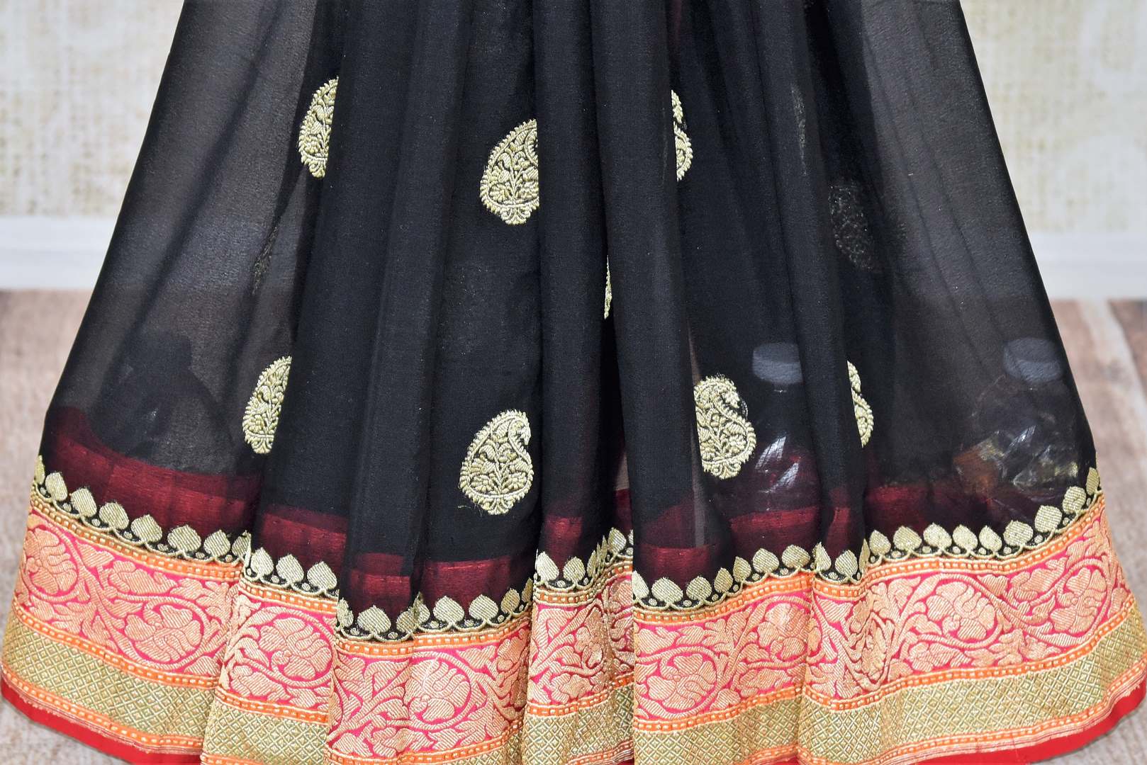 Buy black georgette Banarasi sari online in USA with paisley zari buta and multicolor zari border. Elevate your traditional saree style with beautiful Indian Banarasi saris from Pure Elegance Indian fashion store in USA. We also have a stunning variety of bridal saris for Indian brides in USA. Shop now.-pleats