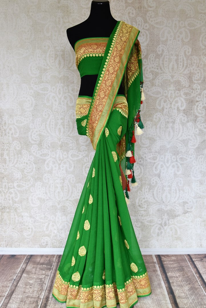 Shop green georgette Banarasi sari online in USA with floral zari buta and foliate zari border. Elevate your traditional saree style with beautiful Indian Banarasi saris from Pure Elegance Indian fashion store in USA. We also have a stunning variety of bridal saris for Indian brides in USA. Shop now.-full view