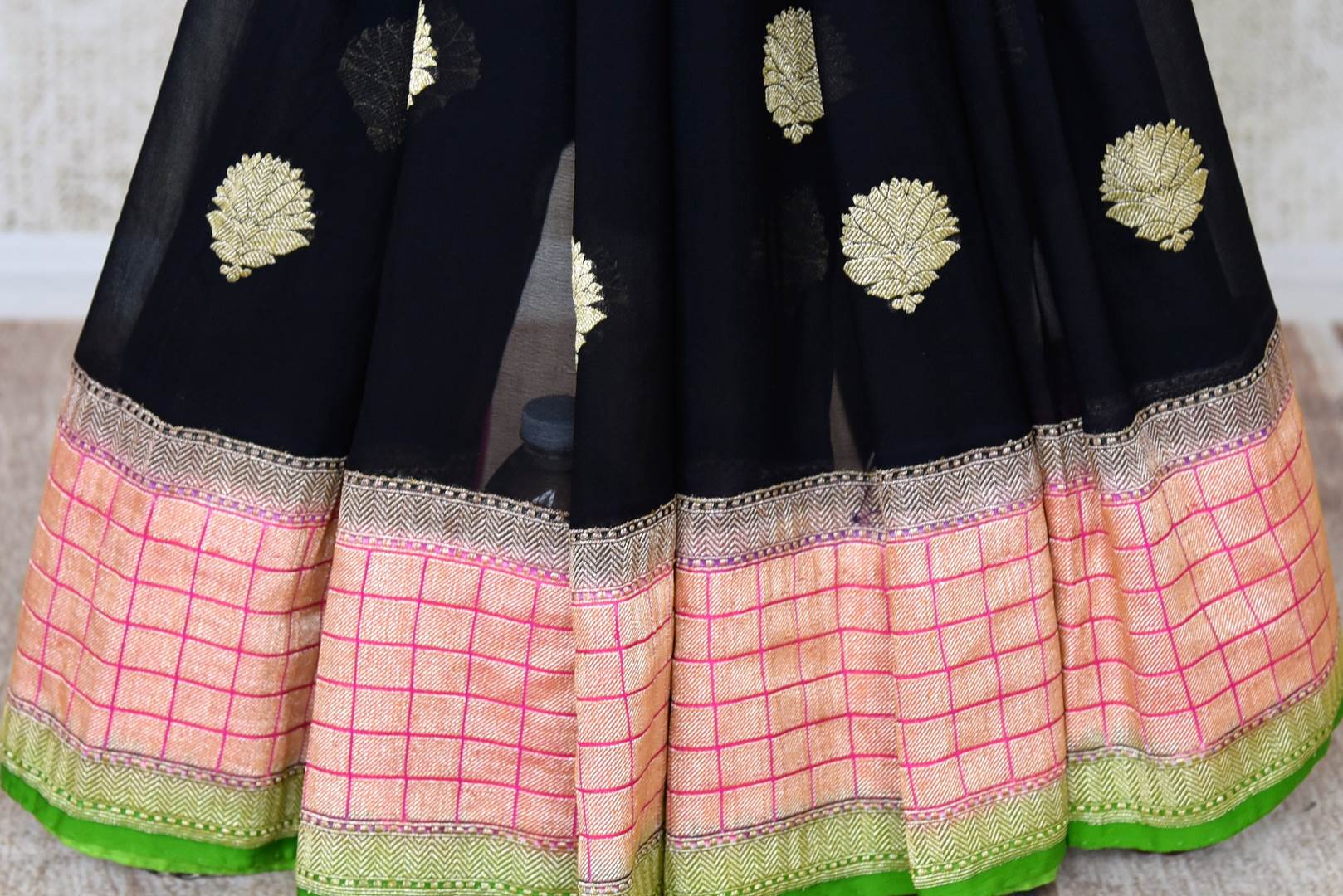 Buy stunning black georgette Banarasi sari online in USA with floral zari buta and check zari border. Elevate your traditional saree style with beautiful Indian Banarasi saris from Pure Elegance Indian fashion store in USA. We also have a stunning variety of bridal saris for Indian brides in USA. Shop now.-pleats
