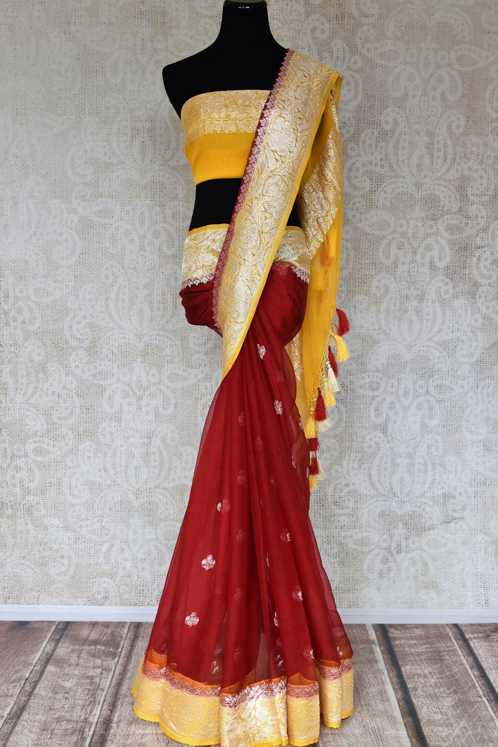 Shop maroon georgette Banarasi saree online in USA with yellow zari border. Elevate your traditional saree style with beautiful Indian Banarasi saris from Pure Elegance Indian fashion store in USA. We also have a stunning variety of bridal saris for Indian brides in USA. Shop now.-full view