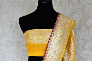 Shop maroon georgette Banarasi saree online in USA with yellow zari border. Elevate your traditional saree style with beautiful Indian Banarasi saris from Pure Elegance Indian fashion store in USA. We also have a stunning variety of bridal saris for Indian brides in USA. Shop now.-blouse pallu