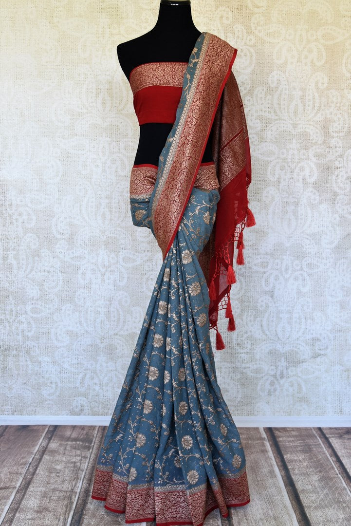Buy blue georgette Banarasi sari online in USA with red zari border. Feel traditional on special occasions in beautiful Indian designer saris from Pure Elegance Indian fashion store in USA. Choose from a splendid variety of Banarasi sarees, pure handwoven saris. Buy online.-full view