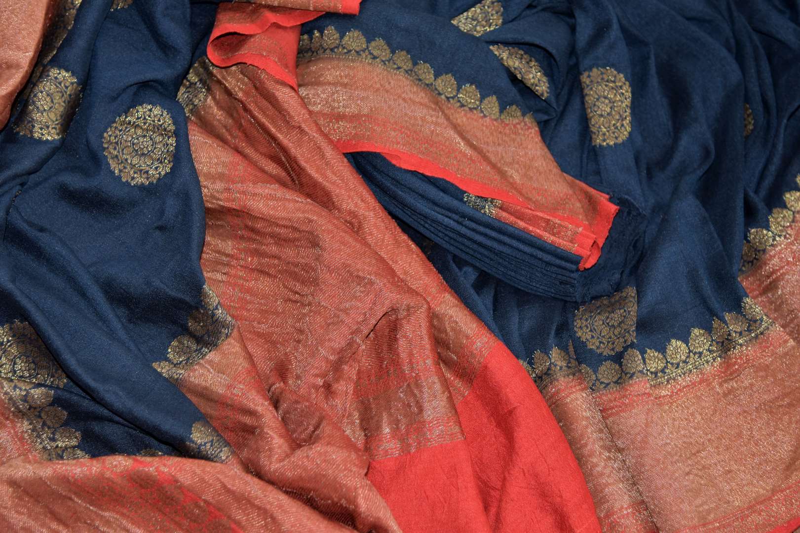 Buy navy blue muga Benarasi sari online in USA with zari buta and zari border. Radiate traditional charm with beautiful Banarasi sarees from Pure Elegance Indian clothing store in USA. Choose from a variety of handwoven saris, Banarasi silk sarees, Banarasi georgette sarees, Banarasi tussar saris for special occasions.-details