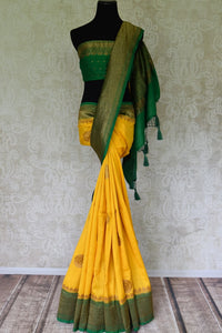 Buy yellow muga Banarasi saree online in USA with green antique zari border. Be an epitome of elegance in exquisite Banarasi sarees from Pure Elegance Indian clothing store in USA.-full view