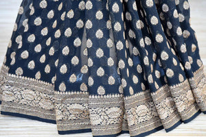 Shop black georgette Banarasi saree online in USA with silver zari buta and zari border. Make your ethnic wardrobe colorful and rich with a splendid collection of Banarasi sarees from Pure Elegance Indian clothing store in USA. Shop online.-pleats