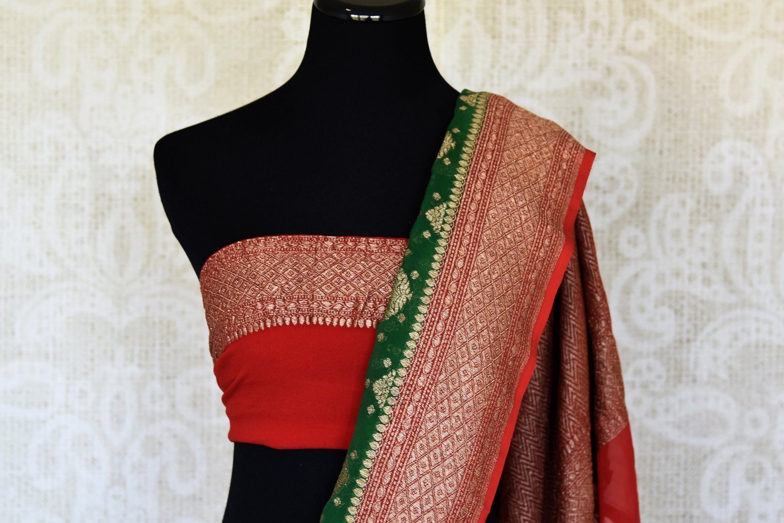 Shop green georgette Banarasi sari online in USA with red zari border. Feel traditional on special occasions in beautiful Indian designer saris from Pure Elegance Indian fashion store in USA. Choose from a splendid variety of Banarasi sarees, pure handwoven saris. Buy online.-blouse pallu