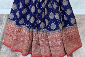 Buy ink blue georgette Banarasi sari online in USA with red antique zari border. Feel traditional on special occasions in beautiful Indian designer saris from Pure Elegance Indian fashion store in USA. Choose from a splendid variety of Banarasi sarees, pure handwoven saris. Buy online.-pleats