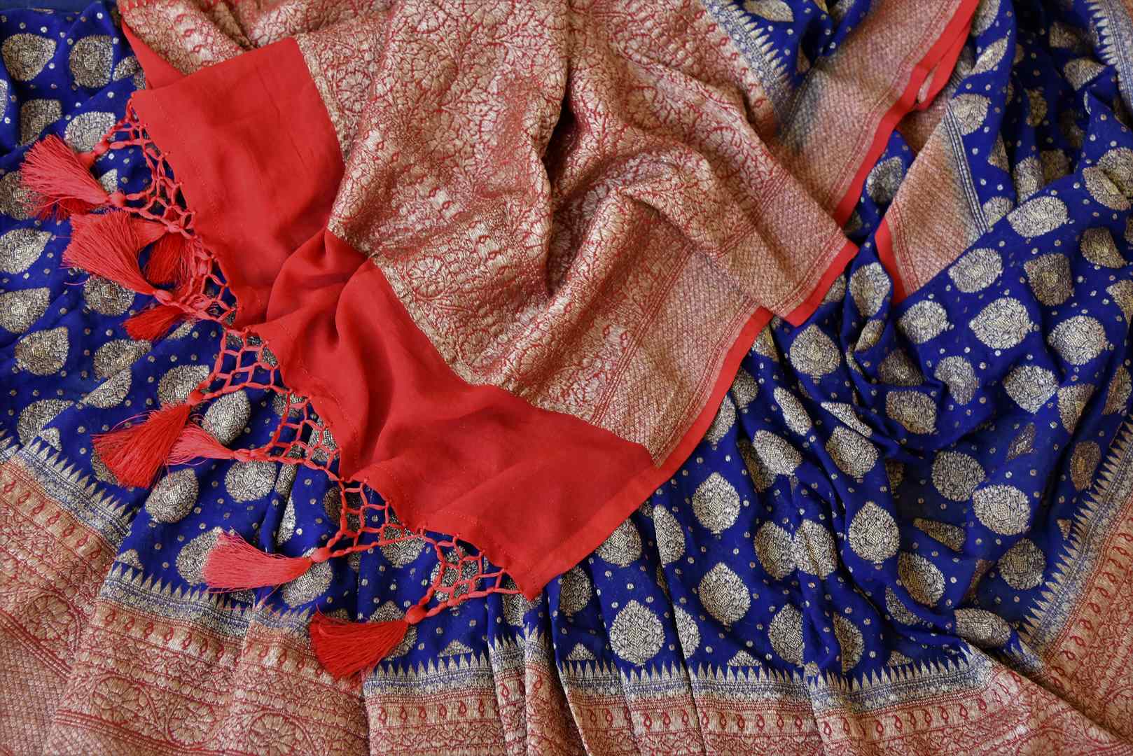 Buy ink blue georgette Banarasi sari online in USA with red antique zari border. Feel traditional on special occasions in beautiful Indian designer saris from Pure Elegance Indian fashion store in USA. Choose from a splendid variety of Banarasi sarees, pure handwoven saris. Buy online.-details