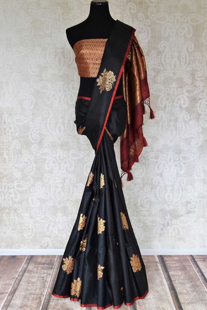 Shop black borderless tussar Benarasi saree online in USA with golden floral buta. Shine bright in best of Indian designer sarees from Pure Elegance Indian fashion store in USA on special occasions. Choose from a splendid variety of Banarasi sarees, pure handwoven saris. Shop online.-full view
